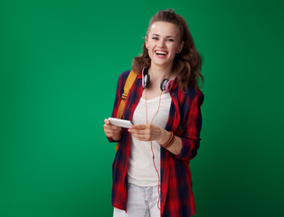 Wall Mural - student woman with smartphone isolated on green background