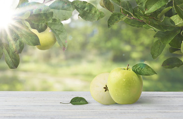 Fresh apple with leaf laying on table