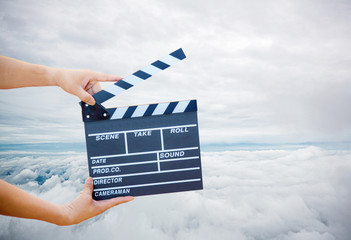 Man hands holding movie clapper.Film director concept.camera show viewfinder image catch motion in interview or broadcast wedding ceremony, catch feeling, woman hand hold a Film Slate with sky.