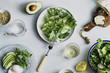 © The Picture Pantry - Top view composition of healthy lunch with green salad plates, avocado and poached egg