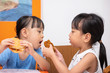 Leinwandbild Motiv Asian Chinese little girl eating burger and fried chicken