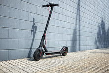 Electric Scooter Near Blue Concrete Wall