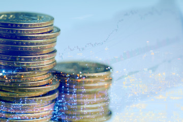 Double exposure of money coins with cityscape