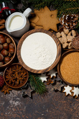 Wall Mural - ingredients for Christmas baking on dark background, vertical top view