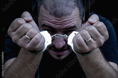 Fotografia, Obraz Portrait of handcuffed criminal man imprisoned.