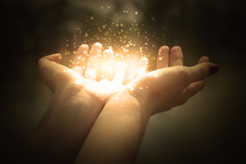 magic particles on the palms of a woman, a stream of magical energy emanating from female hands