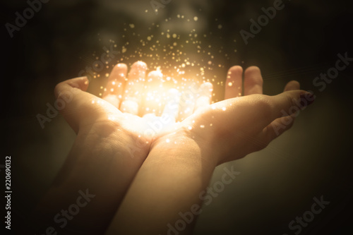 Fotografía magic particles on the palms of a woman, a stream of magical energy emanating fr