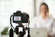 © fizkes - Professional dslr digital camera filming live video blog interview or vlog of woman vlogger coach giving business class or presentation training people online, making videoblog and vlogging concept