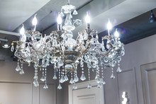 Crystal Chandelier Shines Hanging From The Ceiling In The Room
