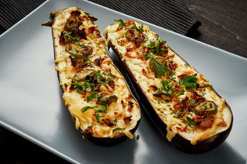 Wall Mural - delicious casserole of aubergine cheese and jalapeno peppers on a gray plate