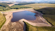 Aerial drone view of low water levels in a reservoir in Wales (Ebbw Vale)