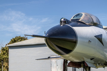 Closeup airplane nose cone with radar array in summe sunshine.