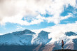 © Klanarong Chitmung - A young lady photographer with a stunning  scenery of rocky mountain covered with snow after the raining day. Cloudy and foggy. Diamond lake track, Wanaka, New Zealand.