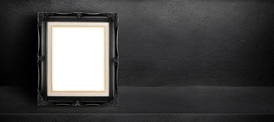 Fototapete - Blank black vintage frame leaning at black interior cement room background,banner mock up template for display of design,leave side space for adding text for advertising