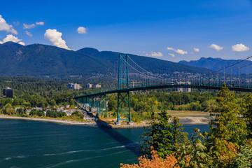 Lions Gate or First Narrows Bridge in Stanley Park Vancouver Canada with North Vancouver and mountains in the background