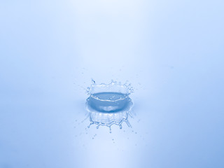 Wall Mural - close up drop of water on blue background