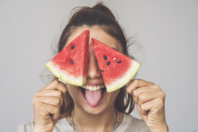 Young Woman Holding Watermelon Slices Popsicles On Her Eyes