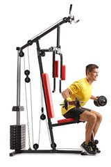 Wall Mural - Young man exercising with barbells on a machine isolated on white background