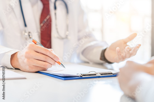Fotografie, Obraz Male doctor and woman patient are discussing something