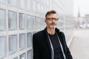 Wall Mural - Trendy middle-aged man deep in thought