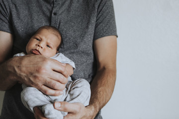 Wall Mural - young father holding his baby