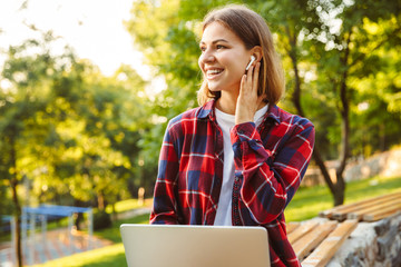 Canvas Print - Amazing lady student listening music with earphones.