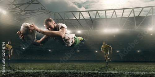 Fototapety Rugby  brudny-gracz-rugby-lapie-pilke-w-locie-na-profesjonalnym-stadionie-rugby