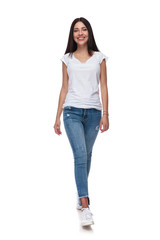 Wall Mural - joyful casual woman wearing jeans walking