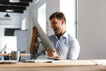 Poster - Cheerful male manager having fun with computer