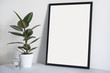 Poster in black frame in nordic stylish modern interior, ficus, living room. Empty space for design layout.