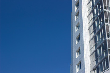 Wall Mural - buildings facade on blue sky background with empty space for copy or text