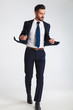 © Viorel Sima - sexy businessman holding his navy suit collar while walking
