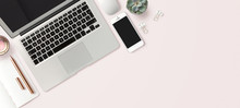 Bright Feminine Banner / Header With A Stylish Workspace With Laptop Computer, Smartphone, Modern Office Accessories And A Small Succulent On A Blush Table, Top View / Flat Lay