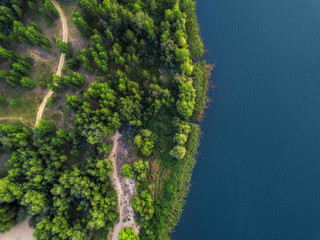 arial veiw of sandy beach, green trees and blue sea (ocean, lake, river). drone shot