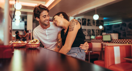 Couple sitting at a diner and talking