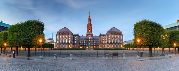 Fototapete - Panoramic view of Christiansborg, palace and government building, the seat of parliament, during morning blue hour, Copenhagen, capital of Denmark