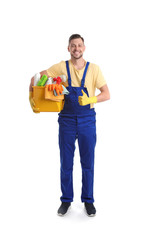 Poster - Male janitor with cleaning supplies on white background