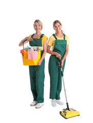 Wall Mural - Female janitors with cleaning equipment on white background