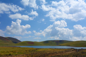 Wall Mural - Lake Akna surrounded by Geghama mountains on a hiking trail leading from Azhdahak volcano in Armenia