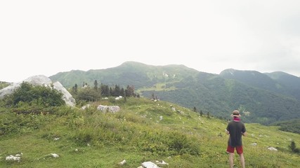 Wall Mural - beautiful landscape man standing on mountain edge aerial view