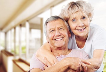 Wall Mural - Happy senior couple smiling on background