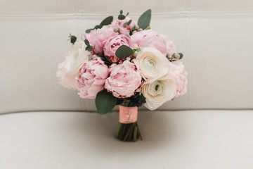 Beautiful wedding bouquet for the bride with pink peonies and white peony roses