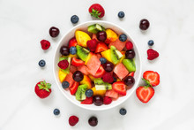 Healthy Fresh Fruit And Berry Salad In A Bowl On White Marble Background. Healthy Food