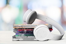 Headphones And Compact Discs  Isolated   On Background