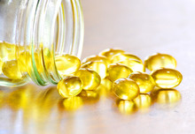 Fish Oil Capsules On Wooden Background, Vitamin D Supplement, Selective Focus, Copy Space For Text.