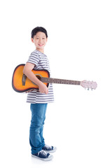 Wall Mural - Young asian boy holding guitar and smiles over white background