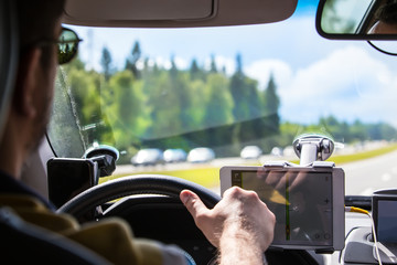 Wall Mural - Driver in the car controls the navigator.