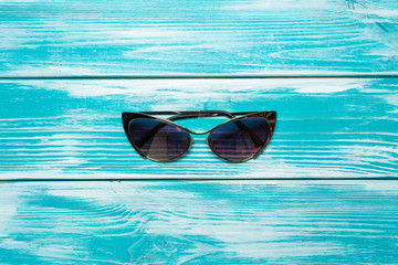 Canvas Print - sun glasses on wooden table