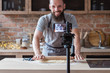 © golubovy - food blogger streaming live. bearded hipster man communicating with subscribers through phone camera. chef rolling out dough with a pin.