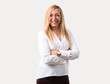 © luismolinero - Middle age blonde woman with white shirt keeping the arms crossed in frontal position. Confident expression on isolated grey background
